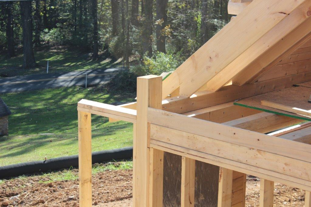 Classic building practices mix with specialized practices when building a log home.  Here you can see that conventional rafters are attached using birdsmouth cuts and hurricane straps.