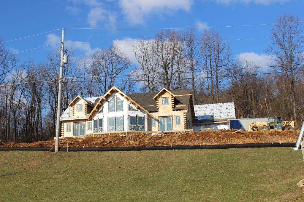 Here's a nice shot from the road showing how the house looks with its windows and doors installed.